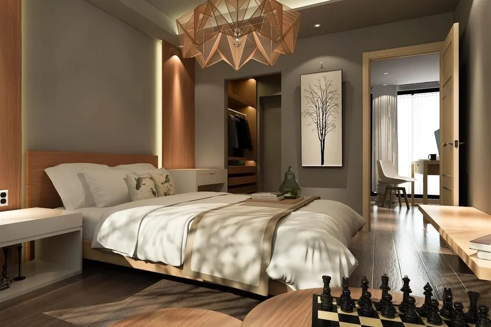 A bedroom with a built-in wardrobe niche beyond the bed wall, keeping clothes out of sight.