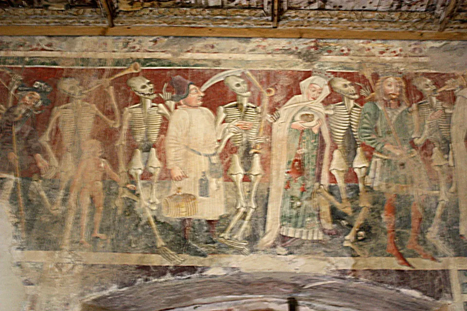 Part of the Dance of Death on the west wall: skeletons leading figures of every rank.