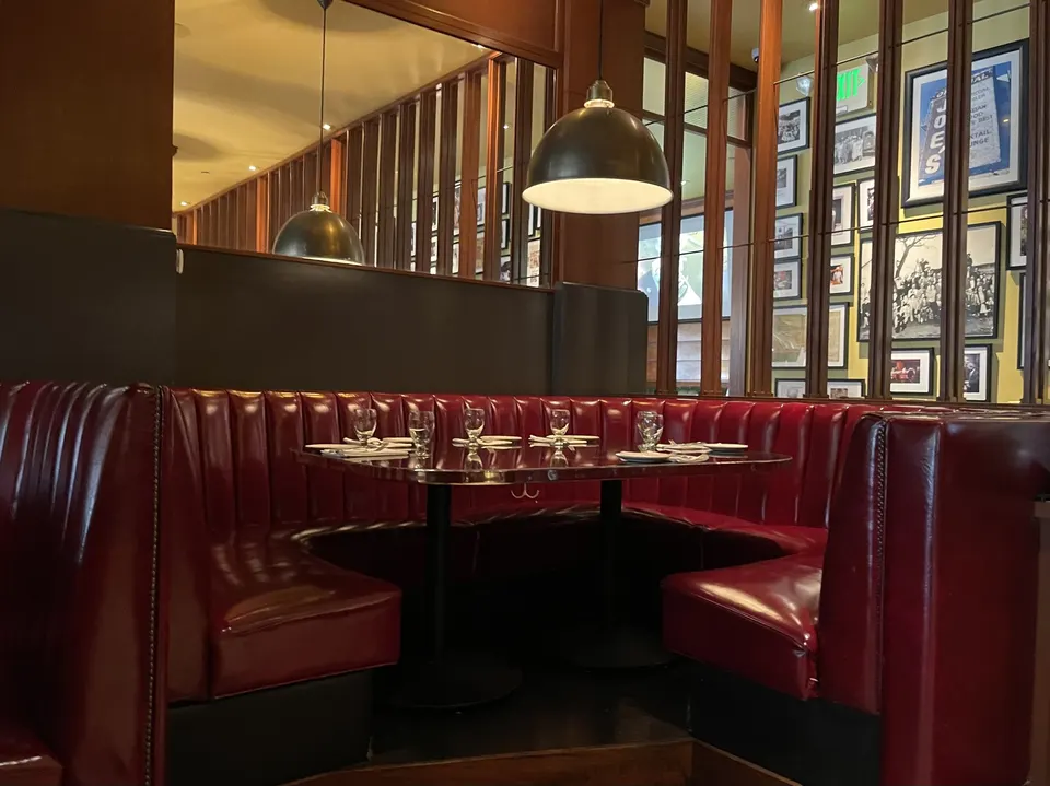 Upholstered banquettes around restaurant tables: popular seats that also soften the sound of a full room.
