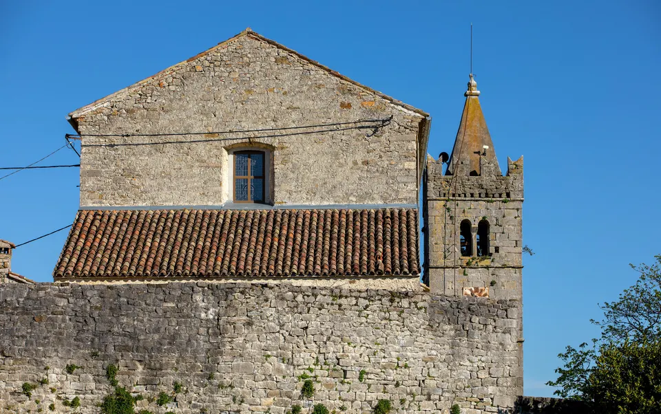 Stone houses and a bell tower in Hum: in historic settings, conservation requirements can shape a design.