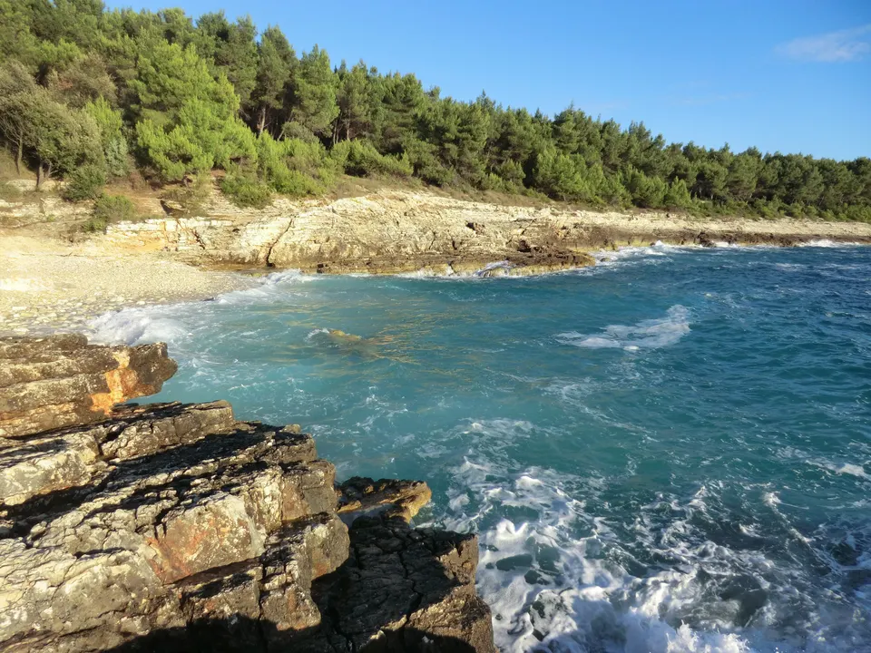 A rocky cove with clear water on Cape Kamenjak, near Premantura.