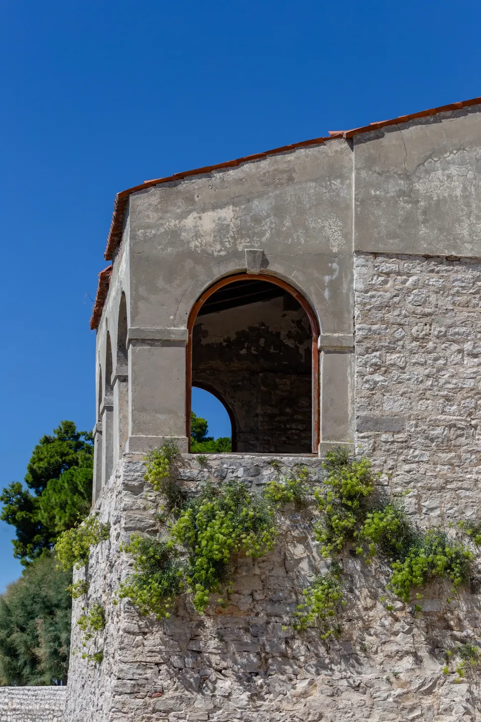 The town loggia of Novigrad, built into the stone walls, with a large arched opening towards the sea.