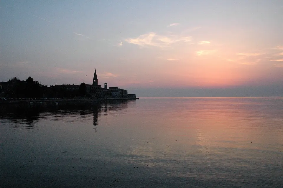 The last light over the sea at Poreč, with the old town on its peninsula.