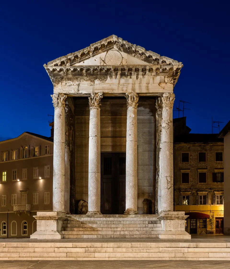 The Temple of Augustus on Pula's Forum, lit at blue hour.