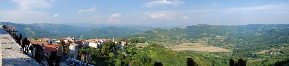 The view from the walls of Motovun over red roofs, green hills and the fields of the valley below.