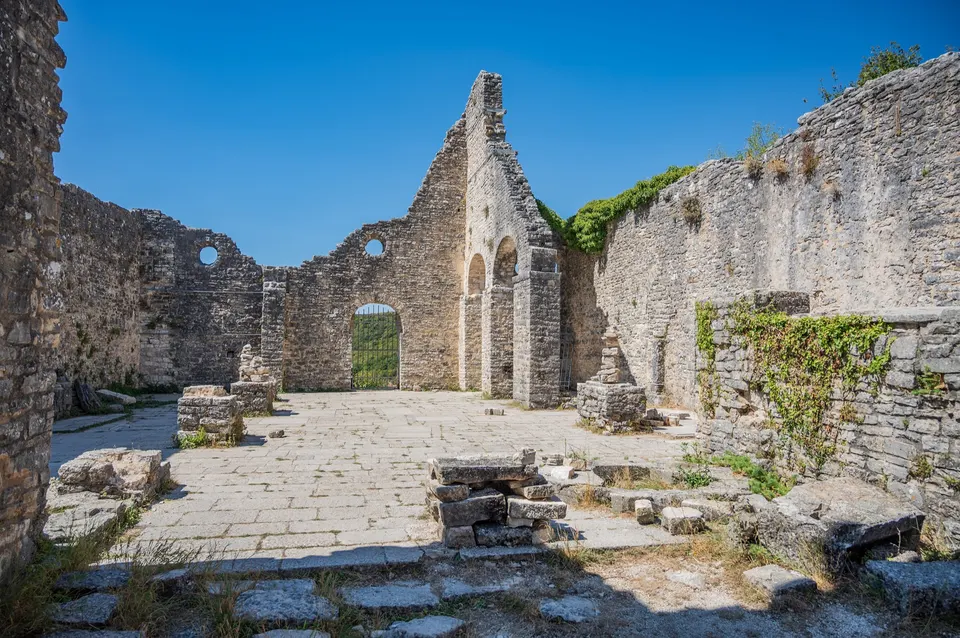 The roofless nave and arcades of the church of St Sophia, the main church of Dvigrad, under a clear blue sky.
