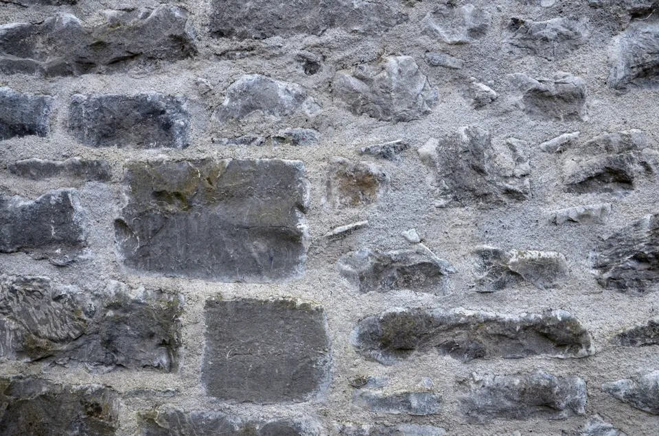 A rubble stone wall freshly pointed with lime mortar, which lets an old wall dry out instead of trapping damp.