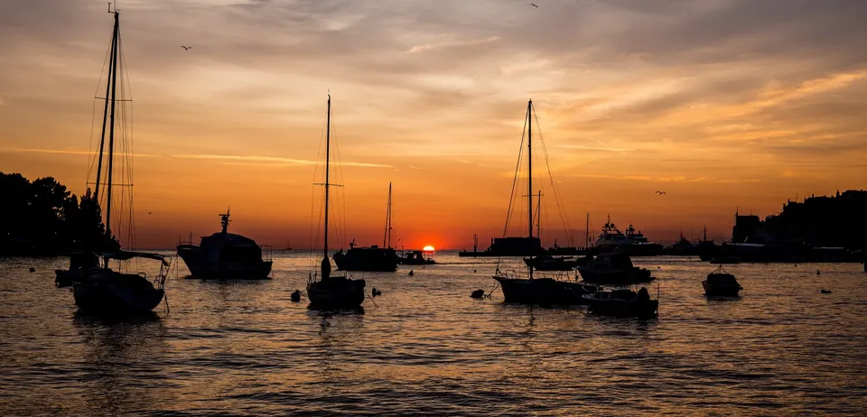 Yachts at anchor off Rovinj as the sun goes down.