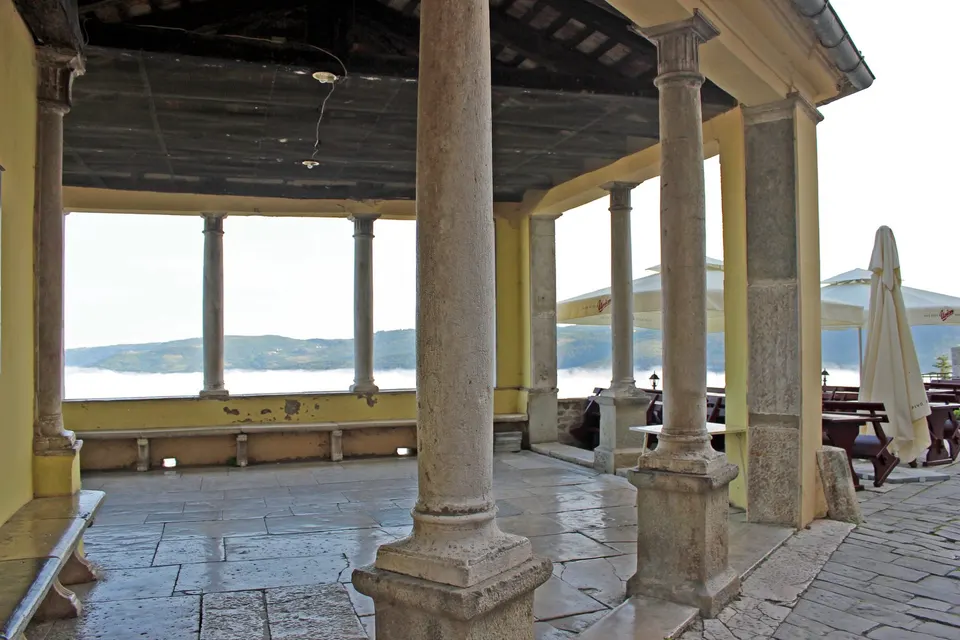 The loggia: shade, stone and a view.